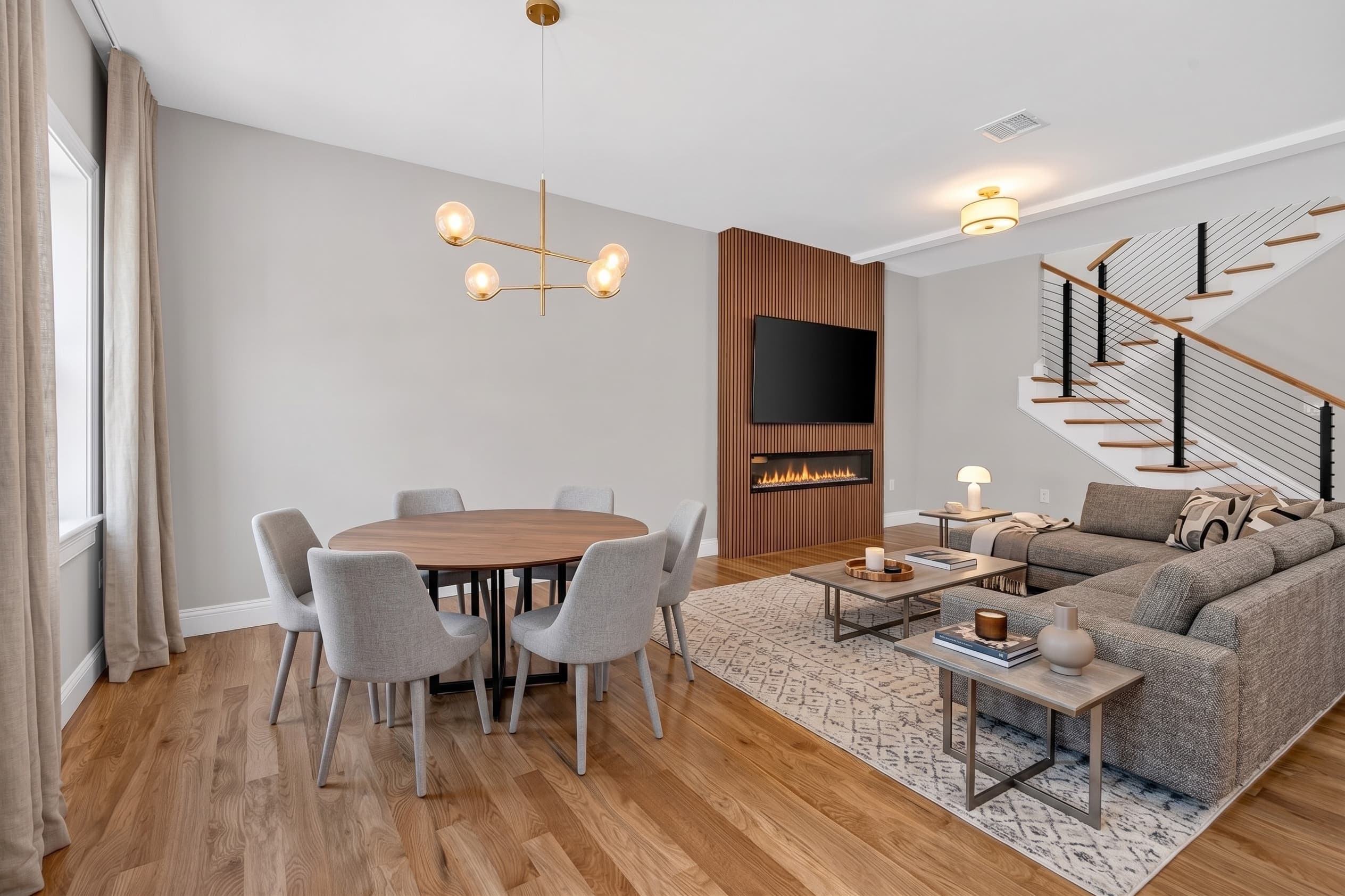 27A open living room with slat-wood accent wall and linear fireplace