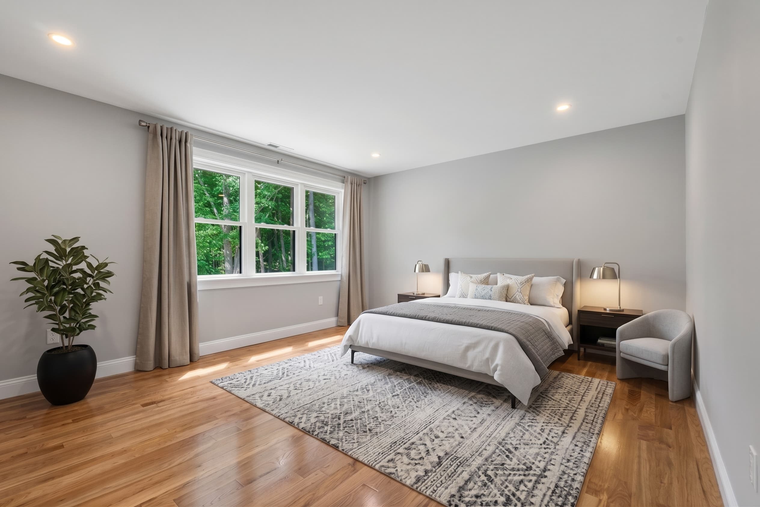 Primary bedroom with wooded views