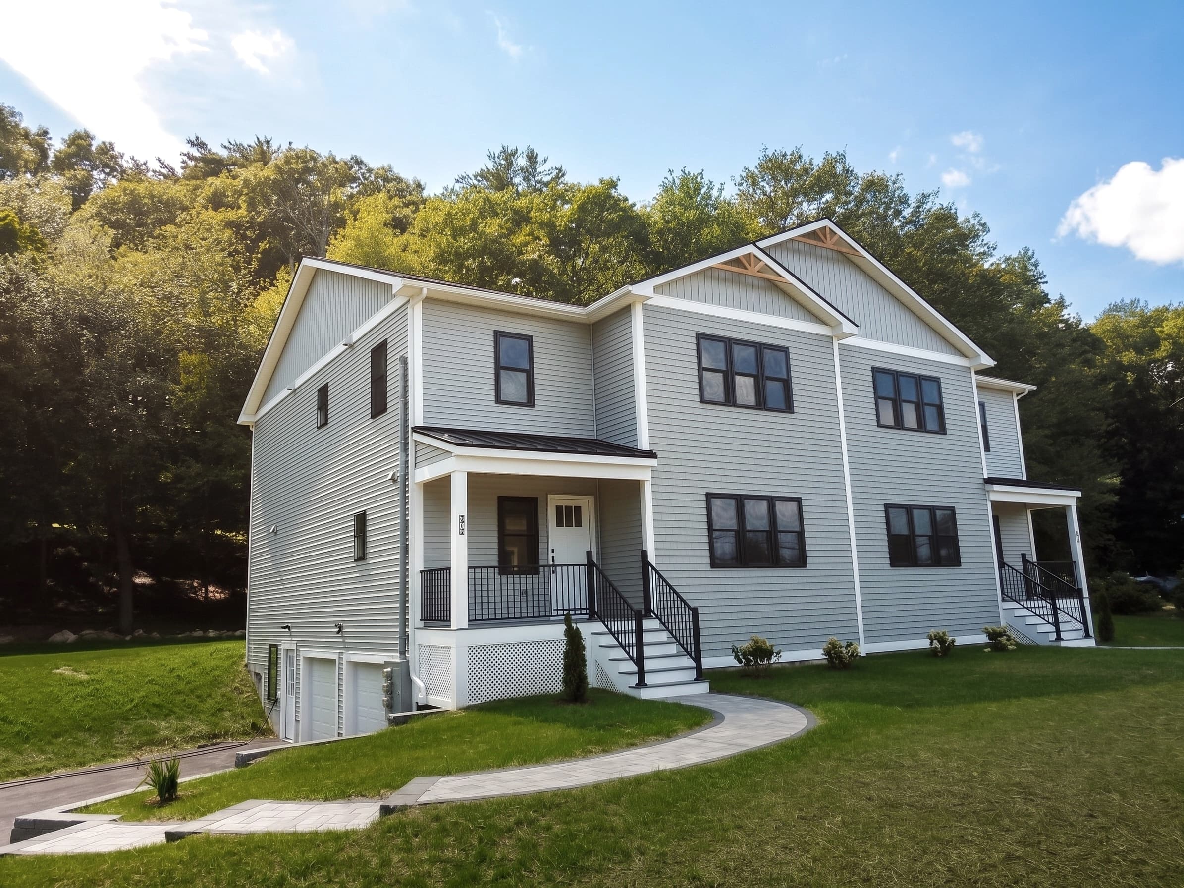 Exterior of 27A Rollins St — new-construction townhome with a covered front porch, viewed from the 27A side