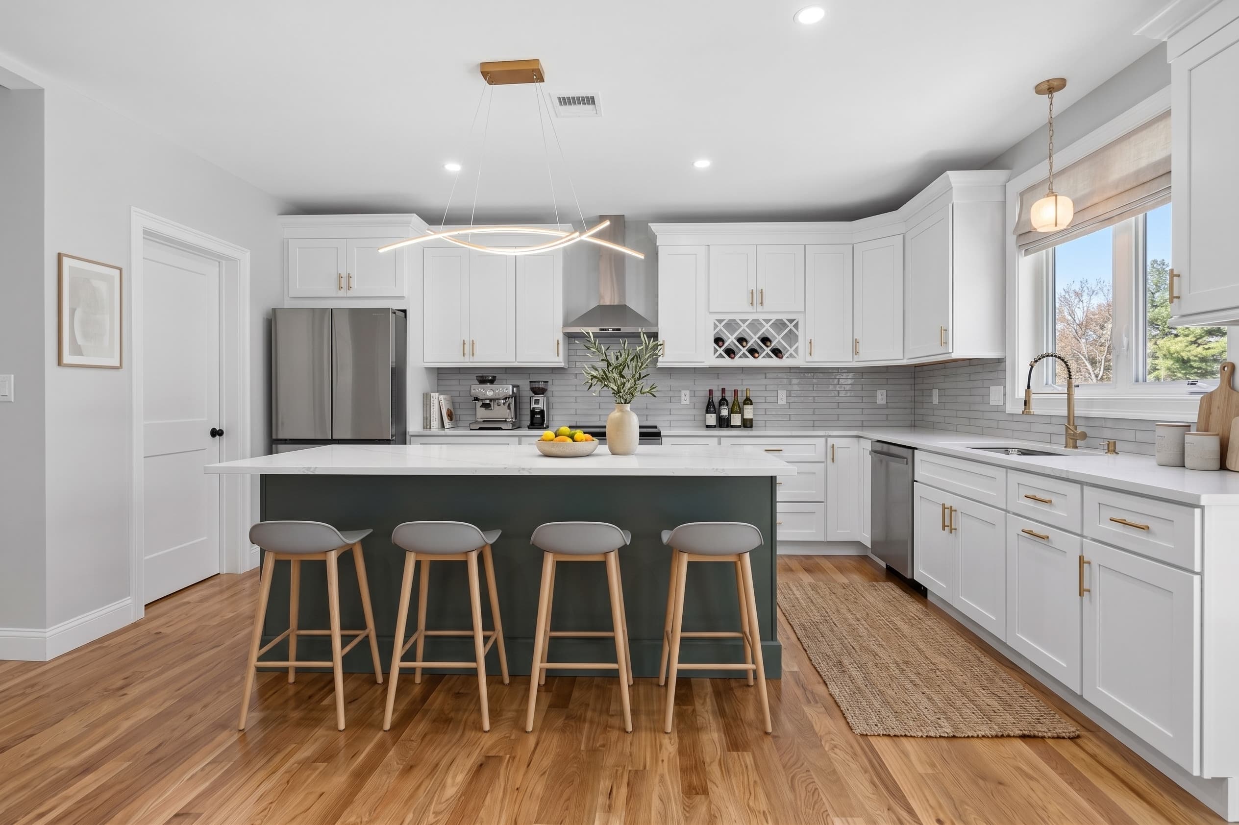 27A kitchen with sage-green island, white cabinetry, and gold hardware
