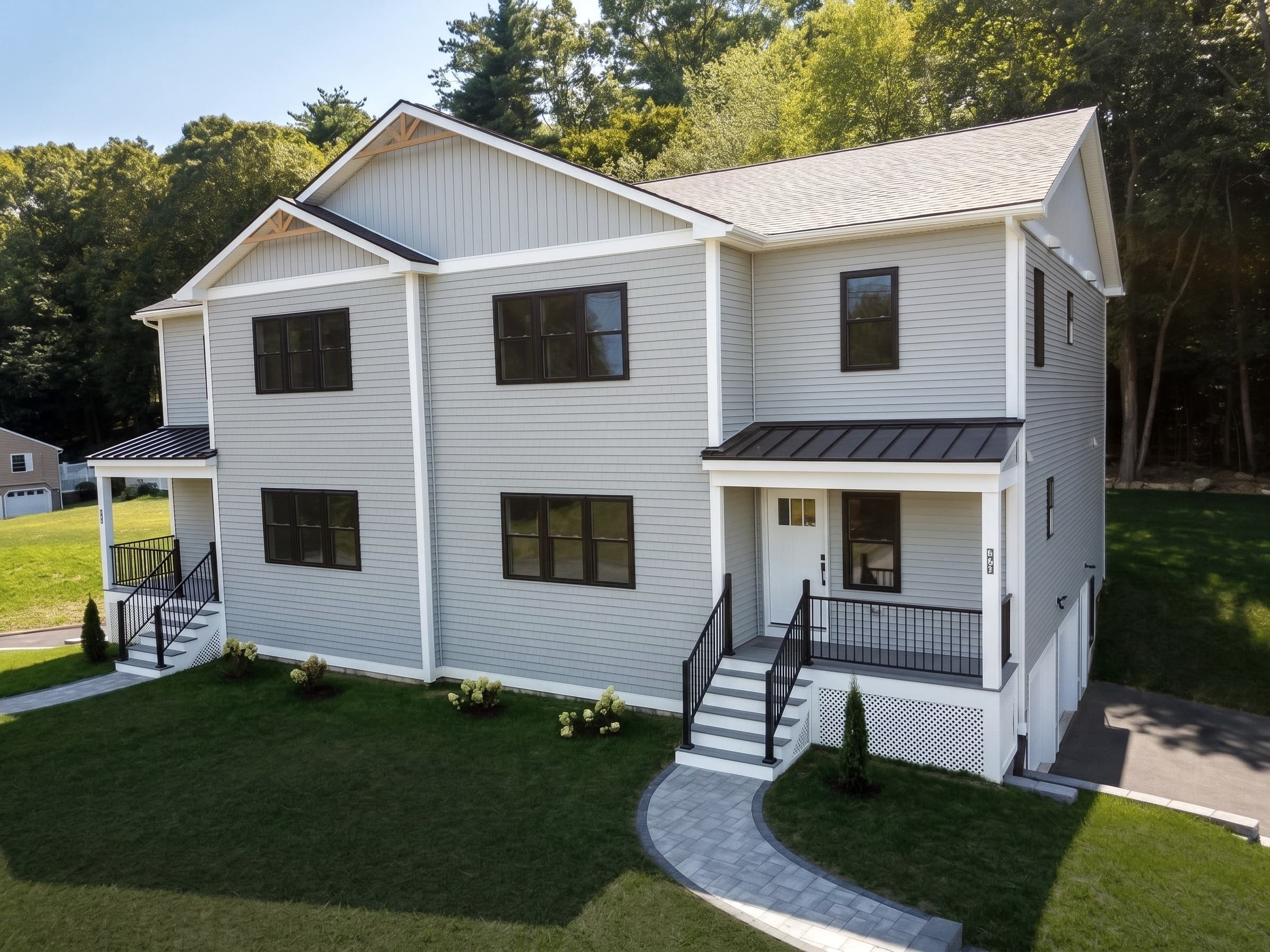 Exterior of 27B Rollins St — new-construction townhome with a covered front porch, viewed from the 27B side